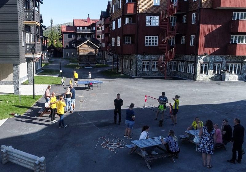 Shell square in the summer, adults and children having coffee, barbecuing, playing various games
